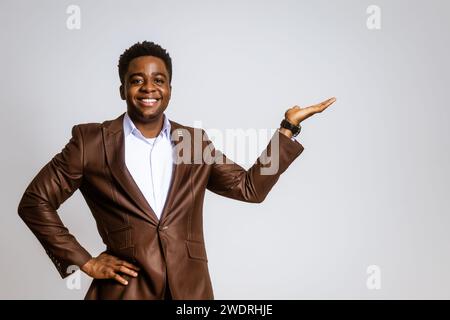 Portrait of happy businessman who is smiling and holding hand at blank space on image. Copy space for your text or advert. Stock Photo