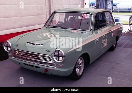 Three-quarters front view of  Pattle and Burton's, Mk1, Green,  1963, Ford Lotus Cortina, on display at the 2023 Silverstone Festival Stock Photo