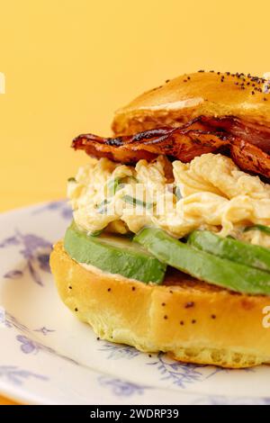 bagel with avocado, sun-dried tomatoes and scramble Stock Photo