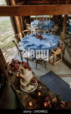 View of interior of barn set up for wedding reception dinner Stock Photo