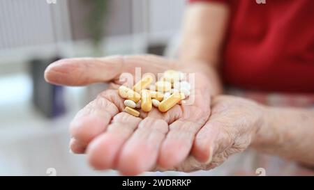 Old Woman Hands Hold Pills And Capsules In Close-Up View Stock Photo