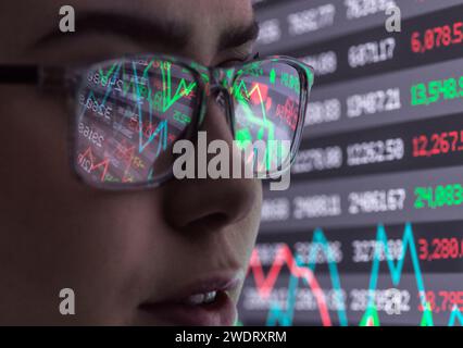 Female analyst viewing financial performances on screen Stock Photo