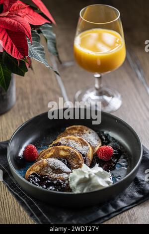 Pancakes with blueberry jam and raspberries in a bowl. Stock Photo