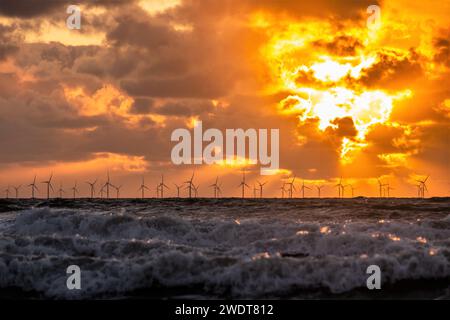 Sunset view from Walney Island across the Irish Sea towards the distant Walney Offshore Wind Farm, Cumbrian Coast, Cumbria, England, United Kingdom Stock Photo