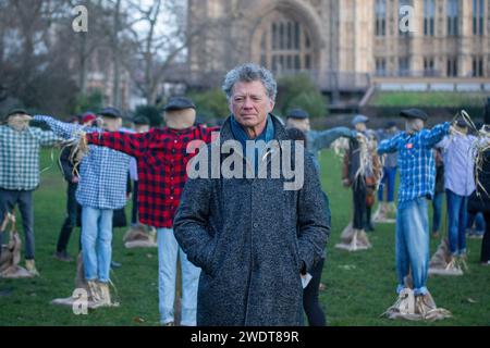 London, England, UK. 22nd Jan, 2024. GUY SINGH-WATSON, founder of Riverford Organic, poses with scarecrows outside British parliament during a protest calling for government the big six supermarkets - Tesco, Sainsbury's, Asda, Morrisons, Aldi and Lidl- to 'get fair about faming. (Credit Image: © Tayfun Salci/ZUMA Press Wire) EDITORIAL USAGE ONLY! Not for Commercial USAGE! Credit: ZUMA Press, Inc./Alamy Live News Stock Photo