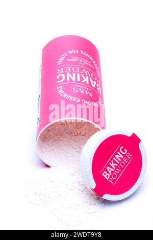 150g Container of Marks and Spencer M&S Baking Powder Spilling onto a White Background Stock Photo