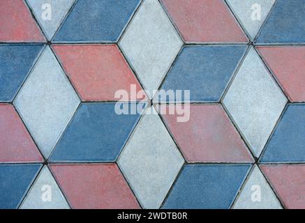 Flat patten of a section of a cobbled sidewalk with cement tiles. Stock Photo