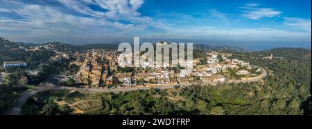 Remains of a 16th-century Begur castle fort atop a forested hill, with panoramic views of the Mediterranean Sea on the Costa Brava Spain Stock Photo