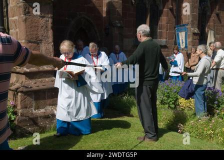 Church Clipping Ceremony St Peters Church, Edgmond, Shropshire Uk 2015.  The congregation hold hands in a circle around the whole of the church, if they can, they did just with the use of belts and ropes to complete the unbroken circle.  England 2010s HOMER SYKES Stock Photo