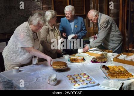 English village life UK 2010s members of the Parish Church of St Peter Edgmond, Shropshire prepare the tea and home made cakes to be consumes after the annual church service  at the Parish Church of St Peter, after the Clipping ceremony. Shropshire 2015 England HOMER SYKES. Stock Photo