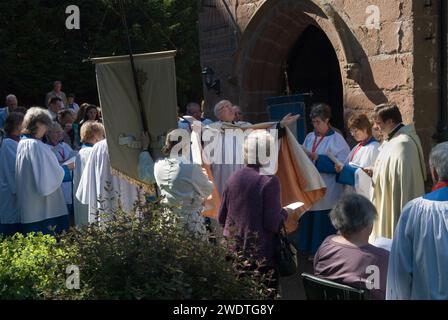 Revd Prebendary Edward Ward conduction an outside Church Clipping Ceremony St Peters Church, Edgmond, Shropshire Uk 2015.  The congregation hold hands in a circle around the whole of the church, if they can, they did just with the use of belts and ropes to complete the unbroken circle.  England 2010s HOMER SYKES Stock Photo