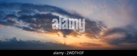 Beautiful sunrise sky with sunrays shining through the clouds. Stock Photo