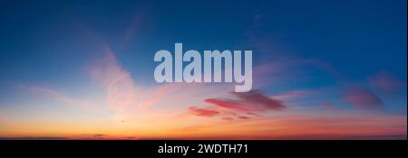 Dramatic colorful sky with soft clouds at sunset. Stock Photo