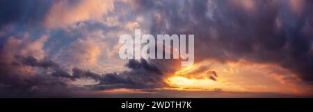 Dramatic sunset sky panorama during golden hour. Stock Photo