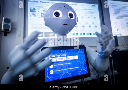 Rostock, Germany. 22nd Jan, 2024. The words 'AI in Rostock' can be read on the display of the Pepper robot. The robot, manufactured by the company Aldebaran Robotics, was programmed by the Rostock scientists for the care of stroke patients. The Minister of Science of Mecklenburg-Vorpommern learned about the current research work during a visit to the Center for Artificial Intelligence (AI) in Mecklenburg-Vorpommern at the University of Rostock. Credit: Jens Büttner/dpa/Alamy Live News Stock Photo