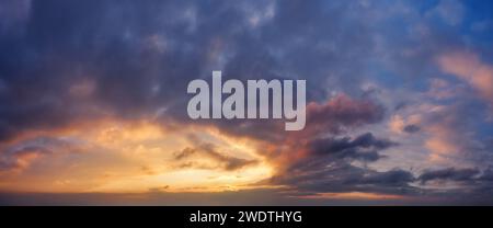 Dramatic sky with dark clouds during sunset. Stock Photo