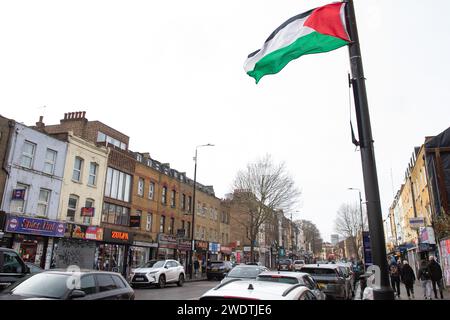 London, UK. 21st January, 2024. A Palestinian flag is pictured flying from a lamp post above Bethnal Green Road in Tower Hamlets. There are many visible symbols of solidarity with Palestinians in the Tower Hamlets area of London, including pro-Palestinian street art and Palestinian flags. Credit: Mark Kerrison/Alamy Live News Stock Photo