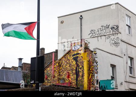 London, UK. 21st January, 2024. A Palestinian flag is pictured flying from a lamp post in Tower Hamlets. There are many visible symbols of solidarity with Palestinians in the Tower Hamlets area of London, including pro-Palestinian street art and Palestinian flags. Credit: Mark Kerrison/Alamy Live News Stock Photo