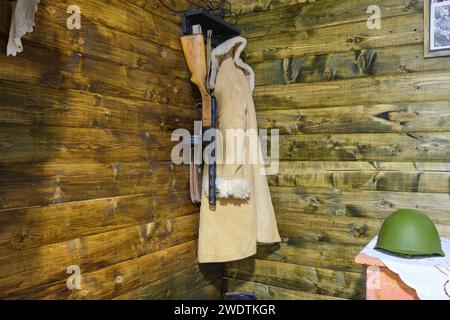 A diorama, recreation of a typical cabin, wood bunker with overcoat and machine gun during WWII, Great Patriotic War. At the Military History Museum o Stock Photo