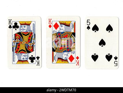 Vintage playing cards showing a pair of kings and a black five isolated on a white background. Stock Photo