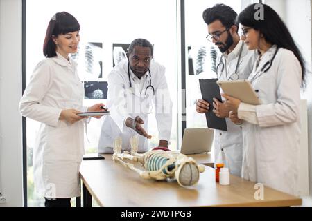 African man teacher teaching anatomy to university students or young doctors. Stock Photo
