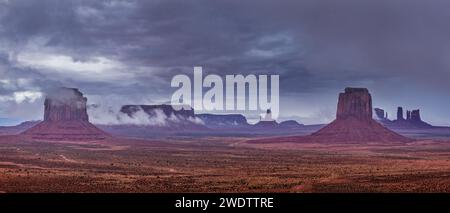 Stormy view of Monument Valley from Artists Point in the Monument Valley Navajo Tribal Park in Arizona.  L-R:  Merrick Butte, Sentinal Mesa with Eagle Stock Photo