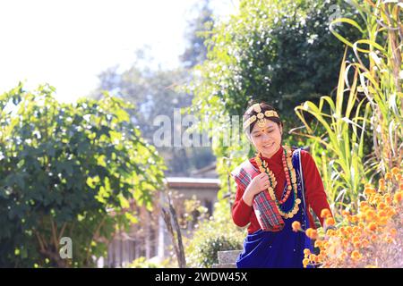 a girl with Gurung traditional dressing a Gurung village in Ghandruk town, Gandaki Province of Nepal, is a point of Annapurna circuit trek and Poonhil Stock Photo