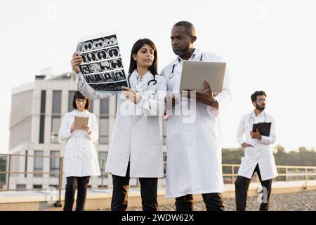 Experienced medical workers talking about patient examination results. Stock Photo