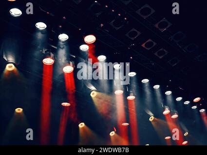 white and red ceiling spotlights working during the show, lights the stage for atmosphere Stock Photo