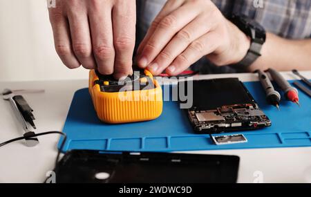 Masrter Cheching Circuit Connection On Microchip Board In Service Center, Hobby FPV Drone Assembling Process Stock Photo