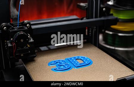 3D Printer Printing Process Of 3D Sign With Blue Color Stock Photo