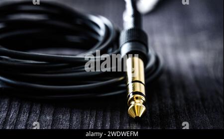audio cable with Jack and mini jack connector, on a dark table, close up view Stock Photo