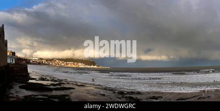 The Tide goes out during a wintery gale giving a view of the Castle Headland from the Spa in Scarborough's South Bay Stock Photo