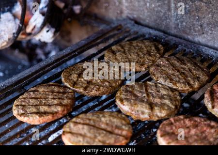 Burgers grilling on the barbecue. Argentine style. Stock Photo