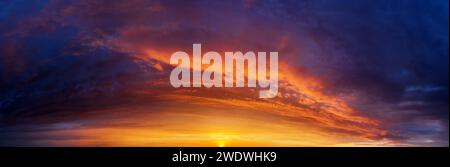 Dramatic sunset sky background with dark clouds. Sky panorama. Stock Photo