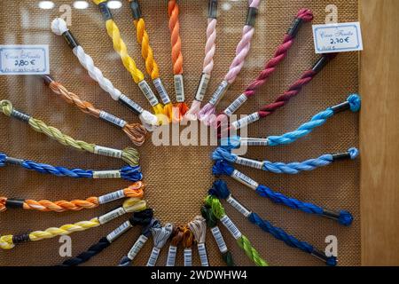 a display of Colourful embroidery threads arranged in a circle Stock Photo