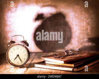 Atmospheric and emotional still life with clock, books and reading glasses Stock Photo