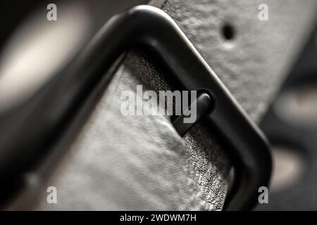 Black leather belt with metal steel buckle macro view. Clothes male accessory with elegance casual design Stock Photo