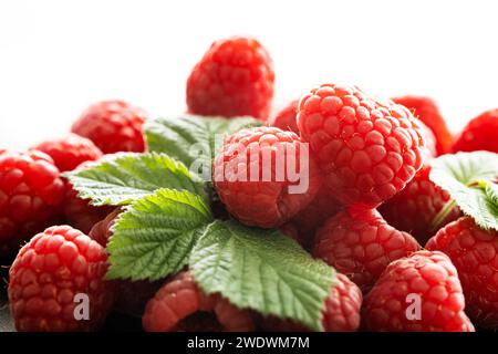 Fresh red raspberries with leaves macro shot Stock Photo