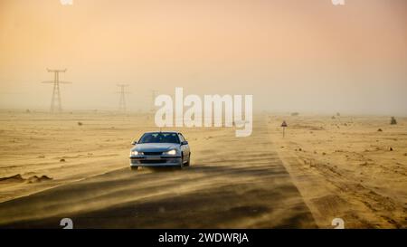 Sand blowing across the road in the desert in Mauritania Stock Photo