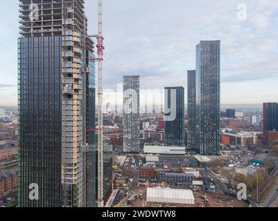 Aerial photograph of Crown Street residential towers under construction with Deansgate Square towers and Manchester city centre, UK behind Stock Photo