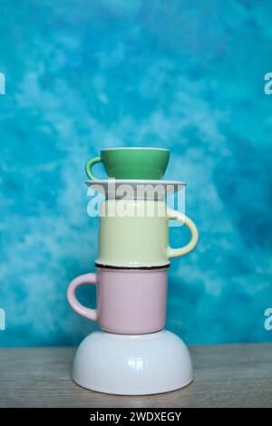 Colorful mugs on a blue background. Minimalism. Stock Photo