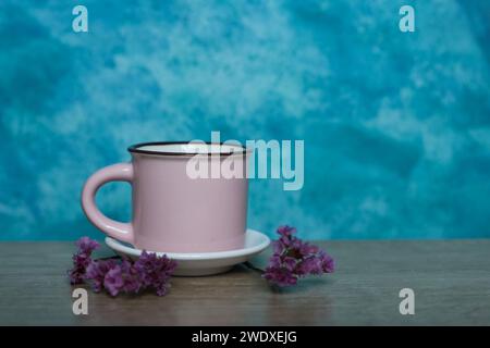 pink mug on a blue background. Minimalism. Stock Photo