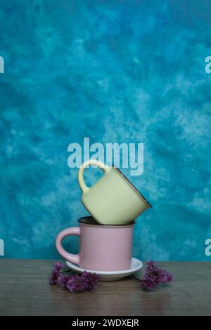 Colorful mugs on a blue background. Minimalism. Stock Photo