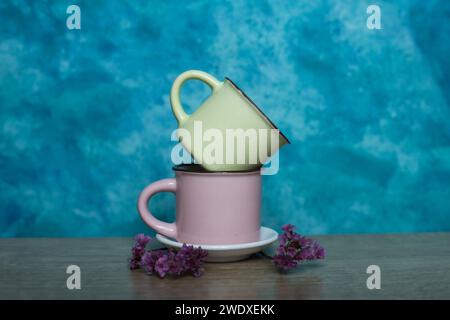 Colorful mugs on a blue background. Minimalism. Stock Photo