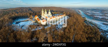 Camaldolese monastery and baroque church in the wood on the hill in Bielany, Krakow, Poland , Aerial panorama in sunset light in winter with Vistula Stock Photo