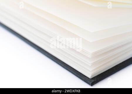 Open book with white blank open pages and a black linen cover, isolated on a white background Stock Photo
