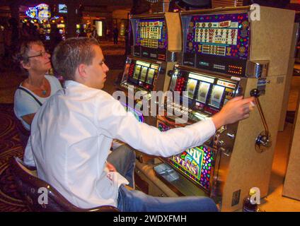 Las Vegas, USA - May 31, 2007: people enjoy playing at the slot machine in Las Vegas, USA. Stock Photo