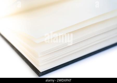 Open book with white blank open pages and a black linen cover, isolated on a white background Stock Photo