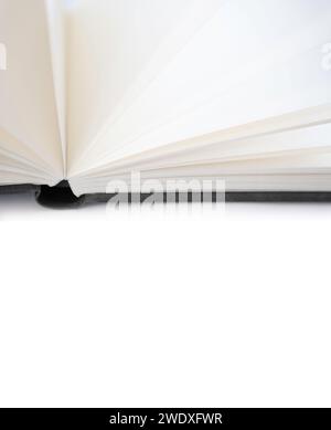 Open book with white blank pages and a black linen cover, isolated on a white background. Narrow depth of field. Copy space Stock Photo